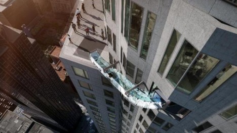 This undated artist's rendering provided by Overseas Union Enterprise Limited shows a glass slide 1,000 feet above the ground off the side of the U.S. Bank Tower in downtown Los Angeles. The 45-foot-long attraction is part of a $  50 million renovation that will also put a bar and open-air observation deck on the top floors of the 72-story building. (Michael Ludvik/OUE Ltd. via AP)